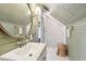 Bathroom showcasing a round mirror, shiplap walls, and a tiled shower at 27 Sessions Nw St, Marietta, GA 30060