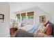 Charming bedroom featuring shiplap walls, three windows, and warm, inviting decor at 27 Sessions Nw St, Marietta, GA 30060