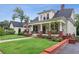 Charming two-story home with an inviting front porch, brick accents, and mature landscaping at 27 Sessions Nw St, Marietta, GA 30060