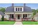 Charming two-story home with white siding, inviting front porch, and well-maintained lawn at 27 Sessions Nw St, Marietta, GA 30060