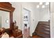 Hallway with stairs, an antique dresser and a view to a sitting room with a fireplace at 27 Sessions Nw St, Marietta, GA 30060
