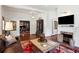 Bright living room featuring hardwood floors, a fireplace, and comfortable seating area at 27 Sessions Nw St, Marietta, GA 30060