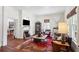 Elegant living room with a fireplace, hardwood floors, and stylish furnishings at 27 Sessions Nw St, Marietta, GA 30060