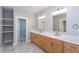 Elegant bathroom featuring dual vanities, stone countertops and marble floors at 3286 Bachelor Street, East Point, GA 30344