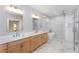 Beautiful primary bathroom featuring a double vanity, large mirror, and glass-enclosed shower and tub at 3286 Bachelor Street, East Point, GA 30344