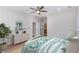 Bright bedroom featuring a ceiling fan, ensuite bathroom, and a stylish dresser with decorative accents at 3286 Bachelor Street, East Point, GA 30344