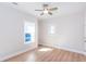 Cozy bedroom with hardwood floors, neutral paint, base molding, a ceiling fan, and two windows at 3286 Bachelor Street, East Point, GA 30344
