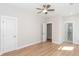 Bright bedroom with hardwood floors and three doors, one leading to a bathroom with walk-in shower at 3286 Bachelor Street, East Point, GA 30344
