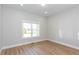 A serene bedroom featuring neutral walls, hardwood floors, and natural light from the window at 3286 Bachelor Street, East Point, GA 30344