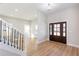 Bright entryway featuring hardwood floors, elegant lighting, and an open staircase at 3286 Bachelor Street, East Point, GA 30344