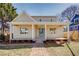 Charming home featuring a quaint brick walkway leading to a covered front porch with a light blue front door at 3286 Bachelor Street, East Point, GA 30344