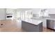 Modern kitchen with white cabinets, stainless steel appliances, and a kitchen island with quartz countertop at 3286 Bachelor Street, East Point, GA 30344