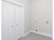 Clean laundry room with a bi-fold closet and gray tile floor at 3286 Bachelor Street, East Point, GA 30344