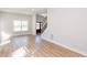 Open-concept living room with wood floors and stairs leading to the second floor at 3286 Bachelor Street, East Point, GA 30344