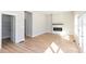 Open living room with fireplace, hardwood floors, and ample natural light from windows and doors at 3286 Bachelor Street, East Point, GA 30344