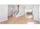 Bright open-concept living room with hardwood floors and a view of the staircase and kitchen at 3286 Bachelor Street, East Point, GA 30344