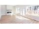 Bright living room featuring fireplace, hardwood floors, large windows, and deck access at 3286 Bachelor Street, East Point, GA 30344