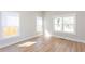 Spacious living room featuring hardwood floors, base molding, and a large window offering natural light at 3286 Bachelor Street, East Point, GA 30344