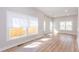 Bright living room featuring new hardwood floors, base molding, and large windows offering great natural light at 3286 Bachelor Street, East Point, GA 30344