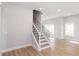 Clean and modern staircase with hardwood steps and black metal railing at 3286 Bachelor Street, East Point, GA 30344