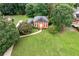 Inviting brick home with black shutters, mature landscaping, and expansive green lawn at 3589 Stone Ridge Trl, Douglasville, GA 30134