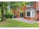 Red brick home backyard with patio, well manicured lawn and mature trees at 3589 Stone Ridge Trl, Douglasville, GA 30134