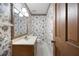 Powder room with a vanity sink, and a floral wallpaper at 3589 Stone Ridge Trl, Douglasville, GA 30134
