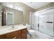 Bathroom with tub and shower combo, floral wallpaper, wood vanity and tile flooring at 3589 Stone Ridge Trl, Douglasville, GA 30134