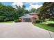 Long driveway leads to a covered three-car carport with an adjacent storage room at 3589 Stone Ridge Trl, Douglasville, GA 30134