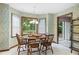 A quaint eat-in kitchen with floral wallpaper and large sunny windows to the backyard at 3589 Stone Ridge Trl, Douglasville, GA 30134