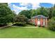 Traditional two-story brick home with black shutters, beautiful landscaping and a large front yard at 3589 Stone Ridge Trl, Douglasville, GA 30134
