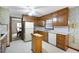 A kitchen with wooden cabinets and white appliances features an adjacent eating area at 3589 Stone Ridge Trl, Douglasville, GA 30134
