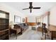 Cozy living room with wood paneling, comfortable seating, and a ceiling fan at 3589 Stone Ridge Trl, Douglasville, GA 30134