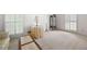 Bright living room featuring large windows, neutral carpet, and elegant furniture at 3589 Stone Ridge Trl, Douglasville, GA 30134