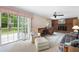 Bright living room with a brick fireplace, sliding glass doors, and comfortable seating at 3589 Stone Ridge Trl, Douglasville, GA 30134