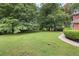Large grass yard featuring large shade trees and manicured landscaping at 3589 Stone Ridge Trl, Douglasville, GA 30134