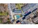 Birds-eye view featuring a community pool and parking, nestled among mature trees at 4282 Roswell Ne Rd # G1, Atlanta, GA 30342
