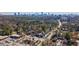 Serene aerial scene of a community surrounded by nature, with a vibrant city skyline in the distance at 4282 Roswell Ne Rd # G1, Atlanta, GA 30342