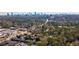 An aerial view of a charming neighborhood with dense trees and a stunning cityscape backdrop at 4282 Roswell Ne Rd # G1, Atlanta, GA 30342