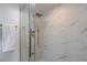 Modern bathroom featuring white marble-style tiling and a glass-enclosed shower with gold hardware at 4282 Roswell Ne Rd # G1, Atlanta, GA 30342