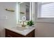 Modern bathroom features a lighted mirror, gold faucet, and white countertop on a wooden vanity at 4282 Roswell Ne Rd # G1, Atlanta, GA 30342