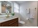 Modern bathroom features gold fixtures, a glass shower, and a lighted mirror above the wooden vanity at 4282 Roswell Ne Rd # G1, Atlanta, GA 30342