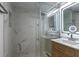 Bathroom features white marble tile shower, glass door, lighted mirror, and wood vanity cabinet at 4282 Roswell Ne Rd # G1, Atlanta, GA 30342