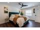 Cozy bedroom with a stylish bed, modern fan, hardwood floors, and natural lighting at 4282 Roswell Ne Rd # G1, Atlanta, GA 30342