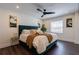 Cozy bedroom with a stylish bed, modern fan, hardwood floors, and natural lighting at 4282 Roswell Ne Rd # G1, Atlanta, GA 30342
