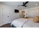 Bedroom with hardwood floors, modern ceiling fan, closet, and television on the wall at 4282 Roswell Ne Rd # G1, Atlanta, GA 30342