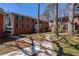 Exterior shot of red brick apartment building with large shade trees, green awning, and sidewalks at 4282 Roswell Ne Rd # G1, Atlanta, GA 30342