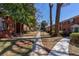 Exterior view of a red brick apartment building with mature trees and landscaping at 4282 Roswell Ne Rd # G1, Atlanta, GA 30342