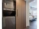 Hallway featuring decorative wood-slat wall panels with laundry and leading to a bedroom at 4282 Roswell Ne Rd # G1, Atlanta, GA 30342