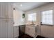 Well-lit kitchen features white cabinetry, marble countertops, stainless steel appliances and a view to the backyard at 4282 Roswell Ne Rd # G1, Atlanta, GA 30342